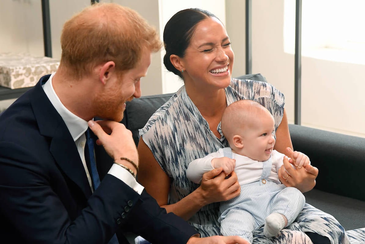 Prince Harry, who reportedly thinks Prince Archie can bring the royal family together, sits with Meghan Markle and their son in 2019