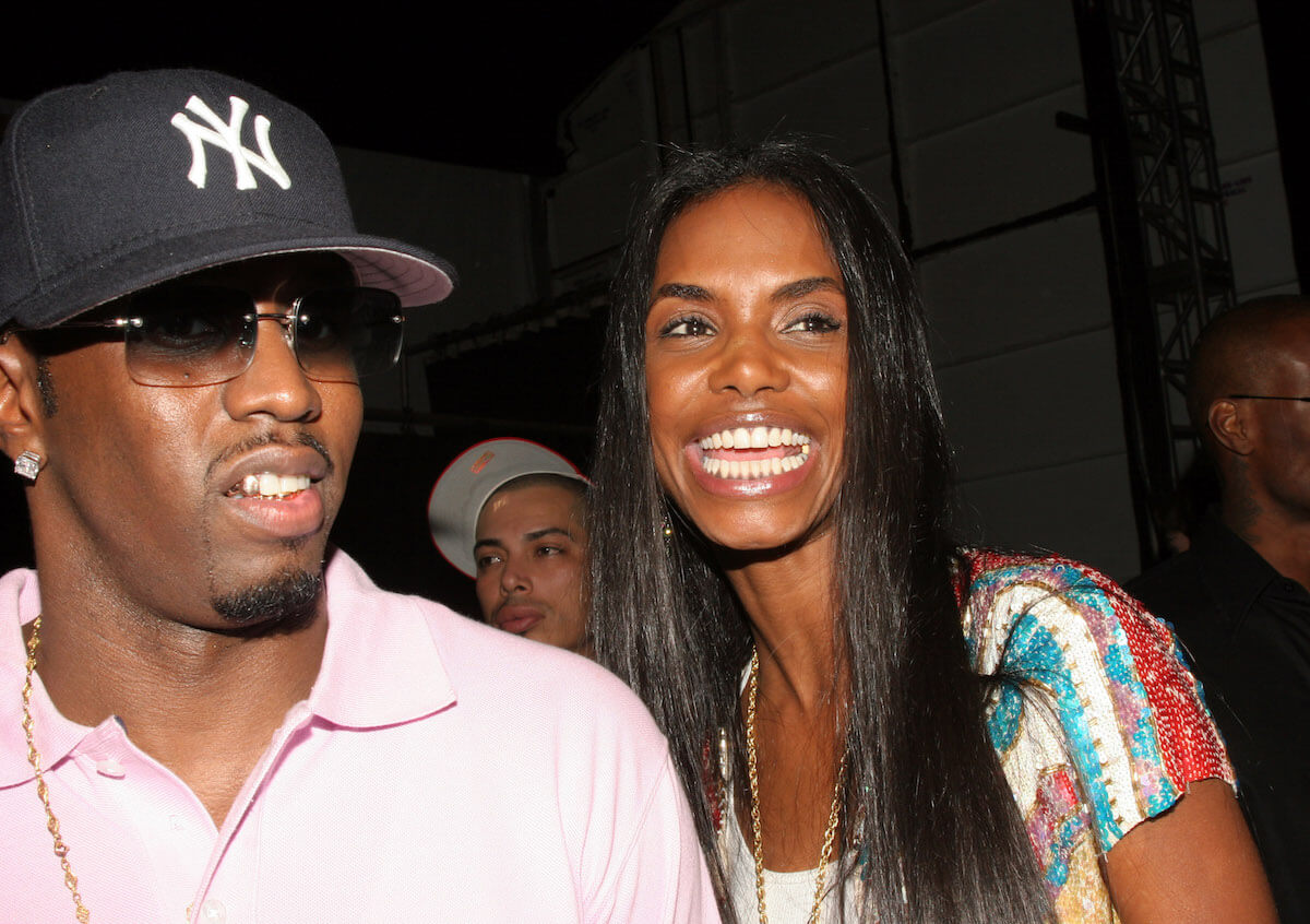 Sean 'P. Diddy Combs' standing next to Kim Porter in 2006. Porter is smiling with an open mouth.