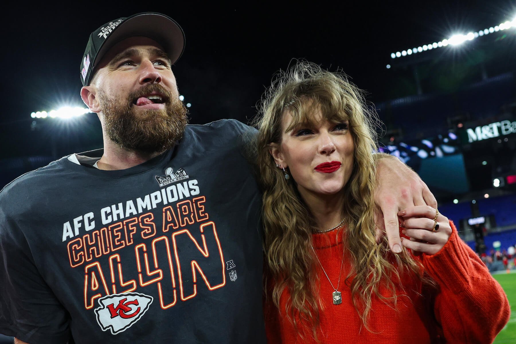 Travis Kelce with his arm around Taylor Swift after an NFL game in 2024