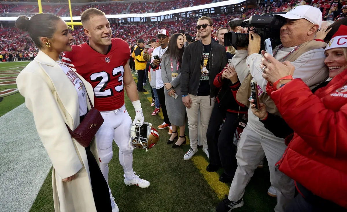 San Francisco 49ers' Christian McCaffrey #23 and his fiancé Olivia Culpo greet fans up before their NFL game against the Baltimore Ravens at Levis Stadium in Santa Clara, Calif., on Monday, Dec. 25, 2023