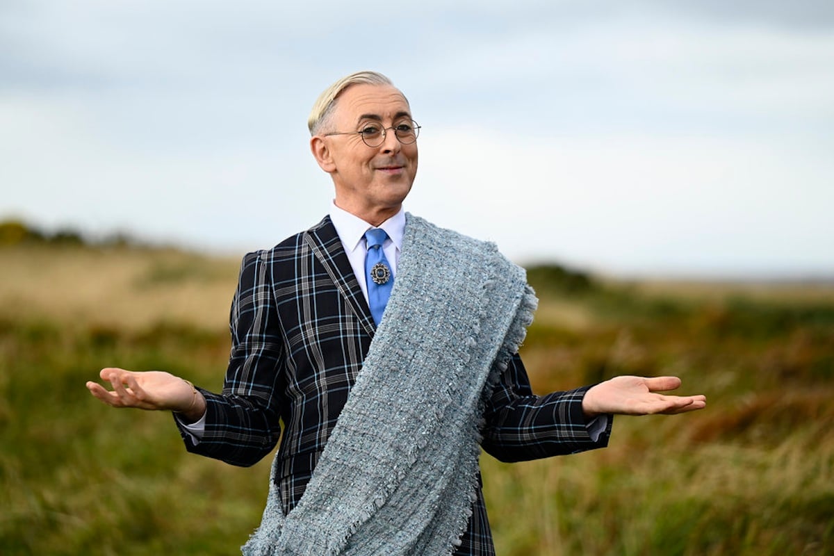 Alan Cumming of 'The Traitors' in a plaid suit and wearing glasses