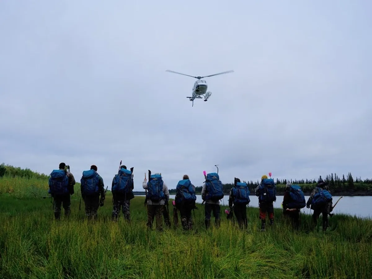 A helicopter flies over 10 'Alone' Season 11 participants