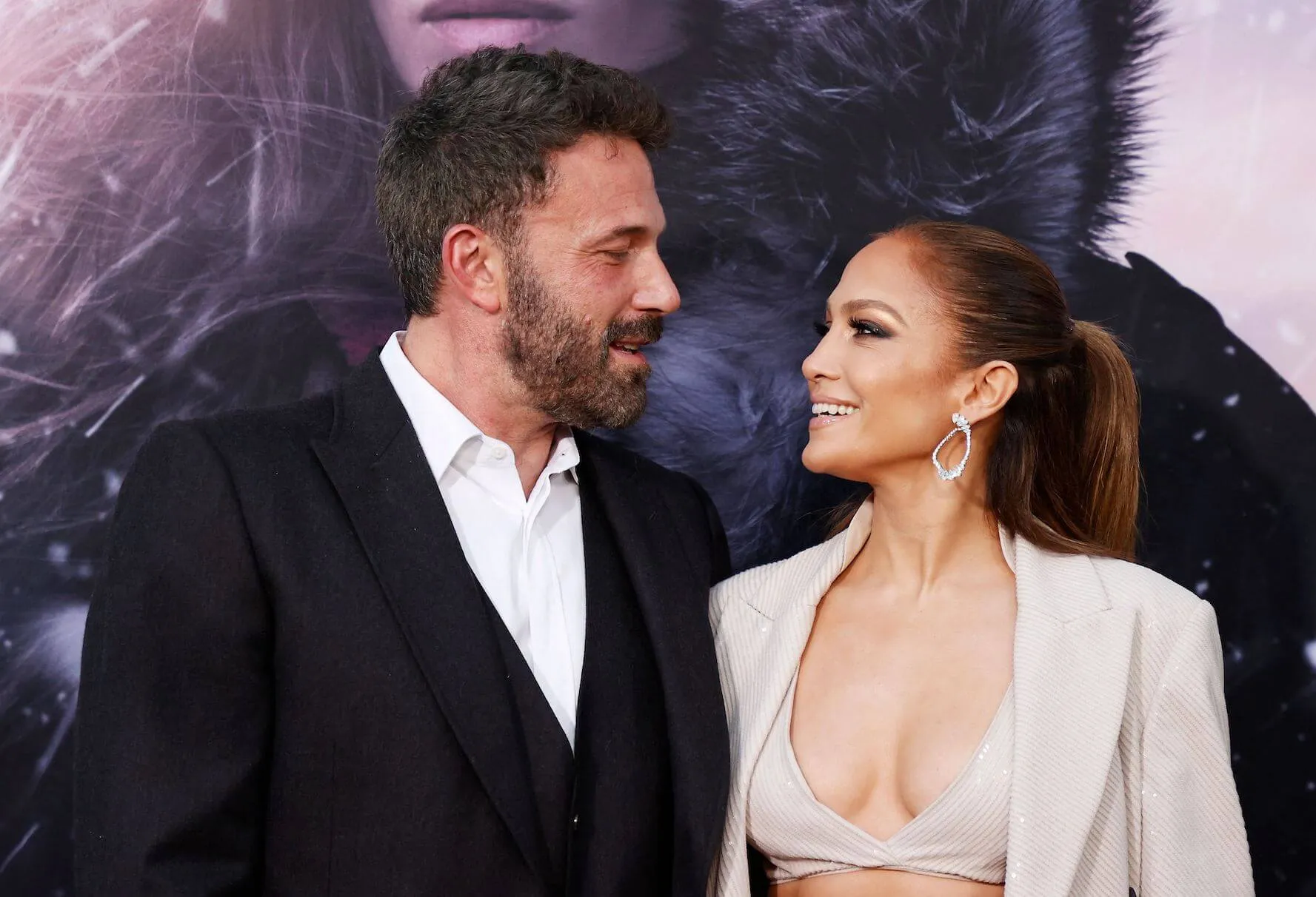 Ben Affleck and Jennifer Lopez looking at each other at a movie premiere in 2023