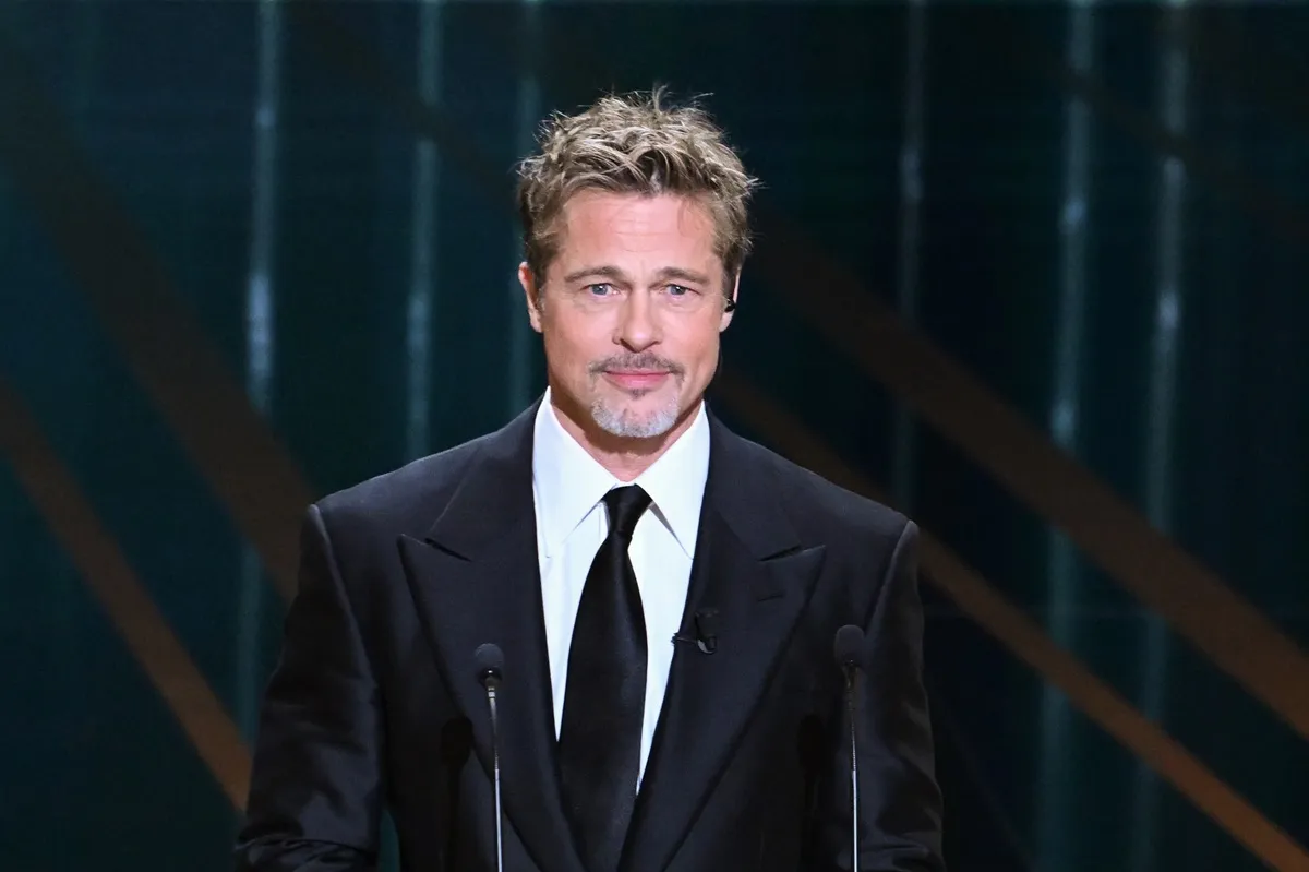 Brad Pitt on stage in a suit at the 48th Cesar Film Awards.