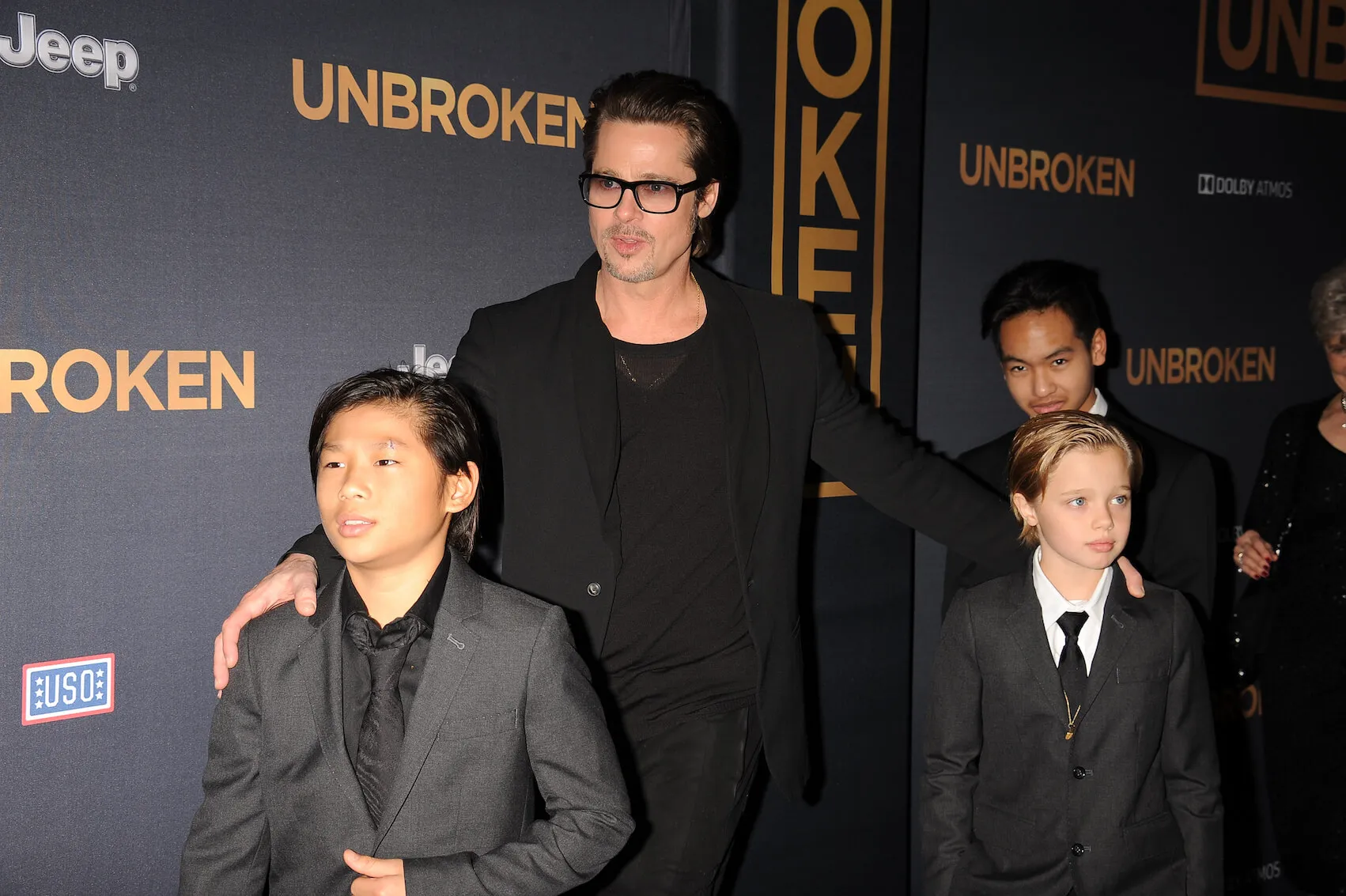 Brad Pitt with Pax Jolie-Pitt, Shiloh Jolie-Pitt, and Maddox Jolie-Pitt at a movie premiere