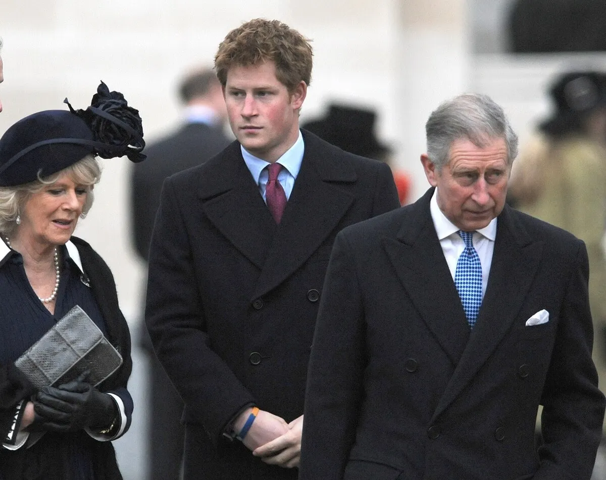 Camilla Parker Bowles, Prince Harry, and then-Prince Charles attend the unveiling of a memorial of The Queen Mother