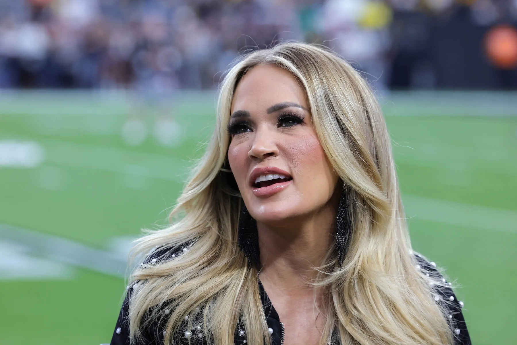 A close-up of Carrie Underwood talking during the NBC Sunday Night Football broadcast before a game between the Pittsburgh Steelers and the Las Vegas Raiders