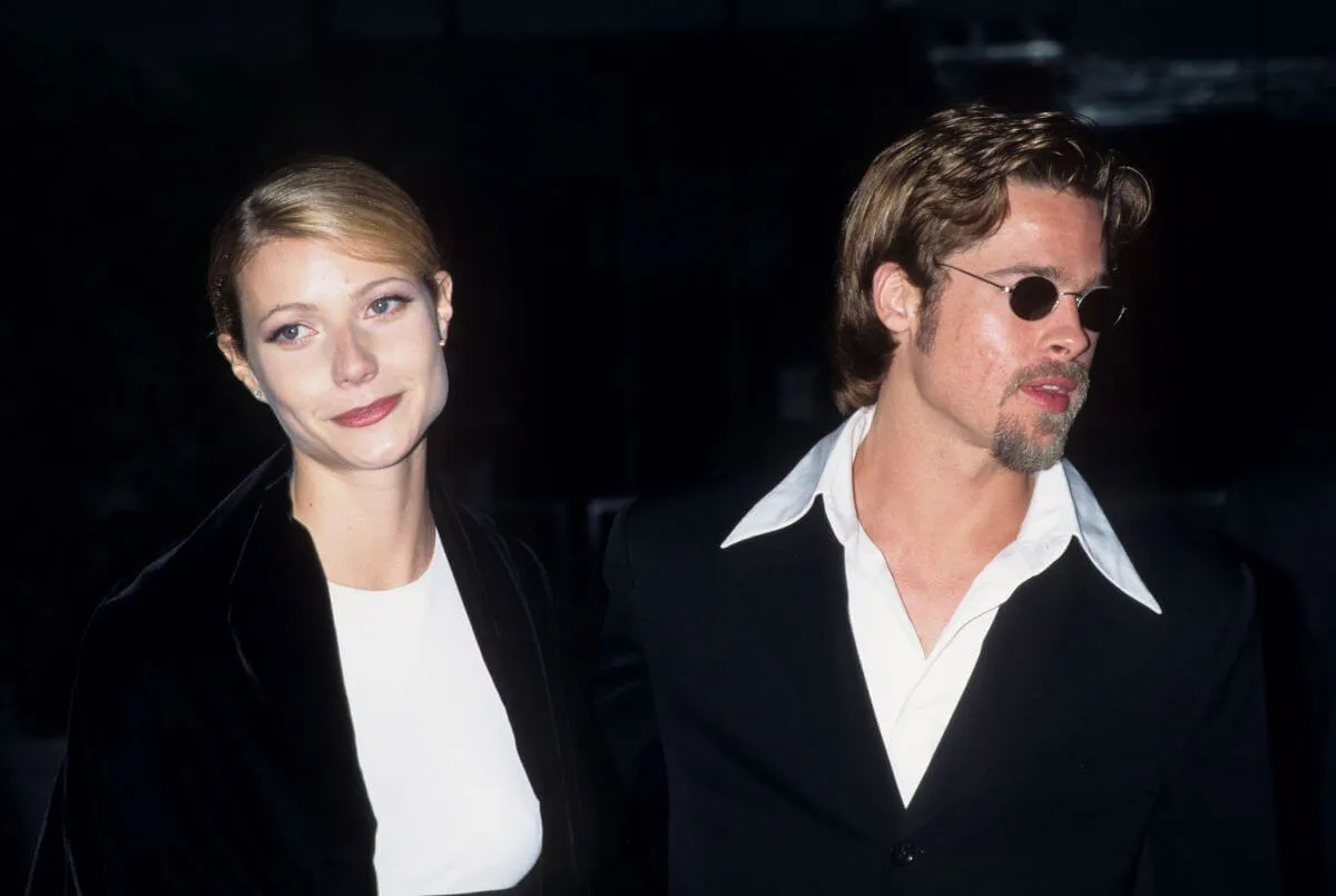 Gwyneth Paltrow and Brad Pitt wear white shirts with black jackets. He wears sunglasses.