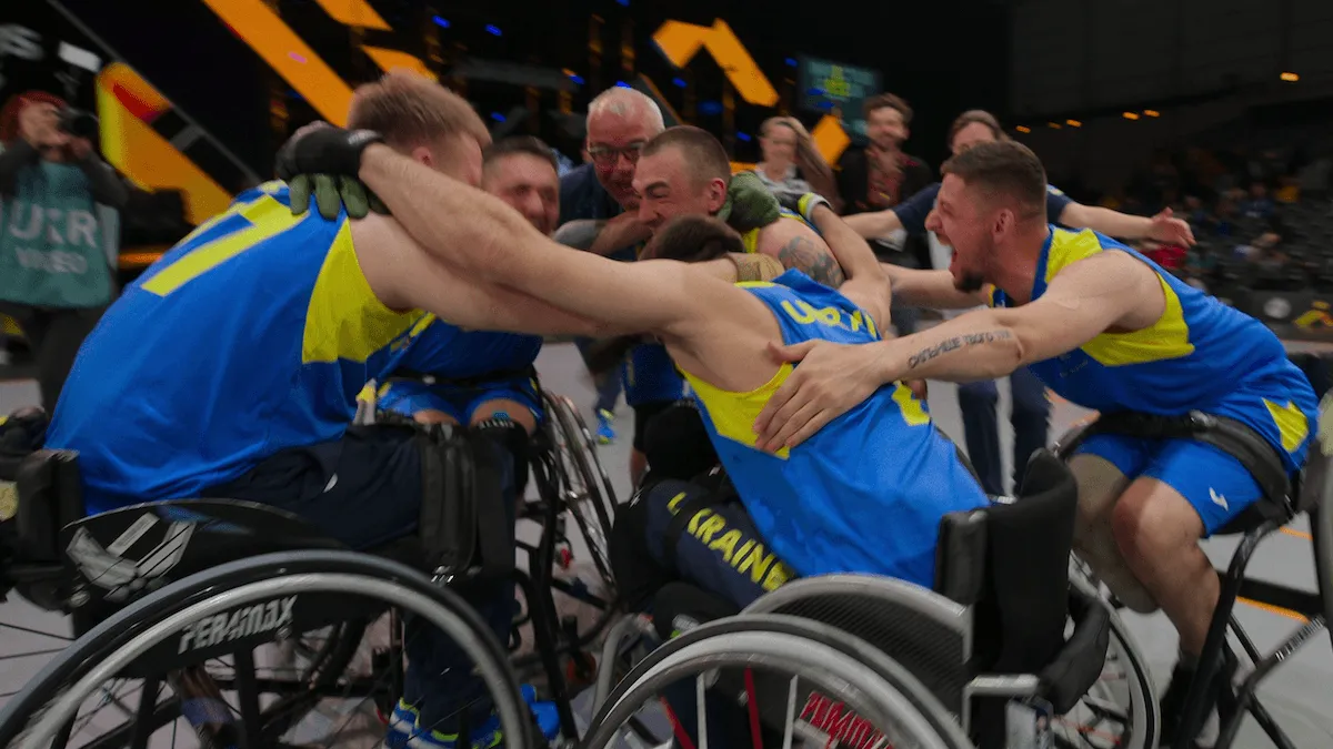 Athletes in wheelchairs celebrating in 'Heart of Invictus'