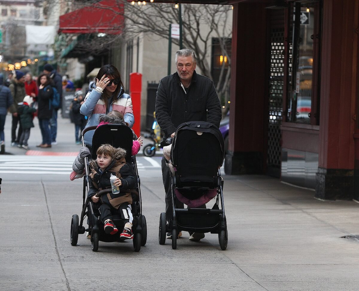 Hilaria Baldwin and Alec Baldwin pushing strollers on an NYC street