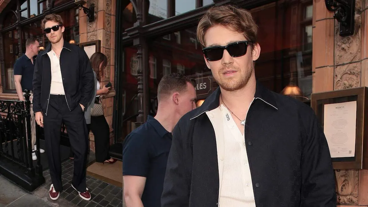 Wearing black pants and a black jacket, Joe Alwyn stands outside of a dinner hosted by Gucci