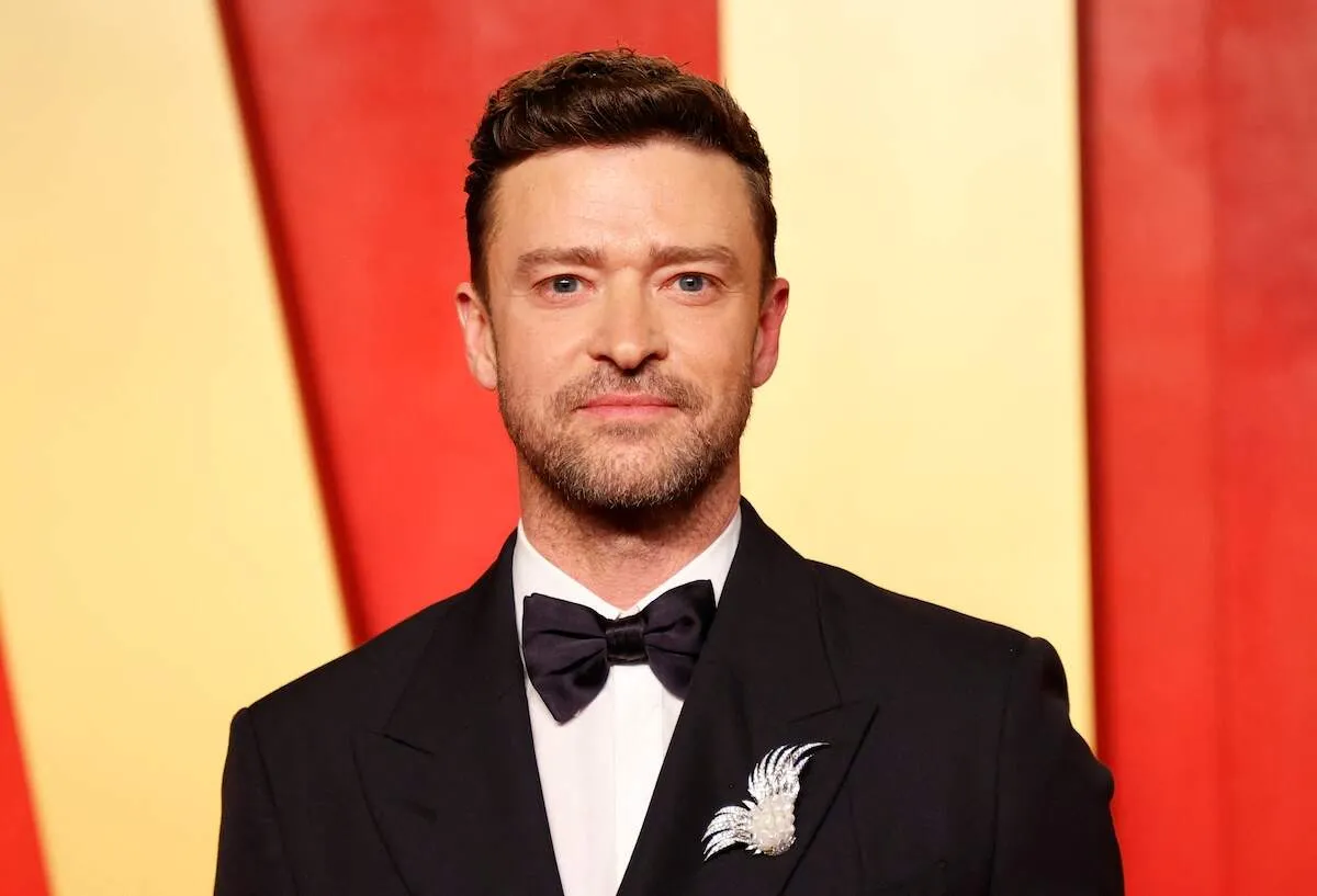 Singer Justin Timberlake poses in a tuxedo on the red carpet for the 2024 Vanity Fair Oscars Party