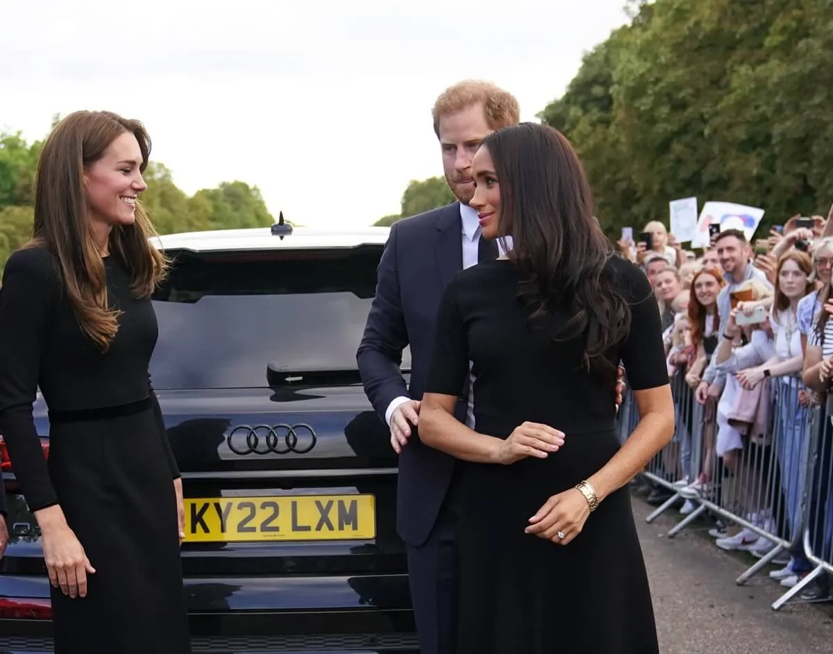 Kate Middleton, Prince Harry, and Meghan Markle meet members of the public on the Long Walk at Windsor Castle following Queen Elizabeth's death