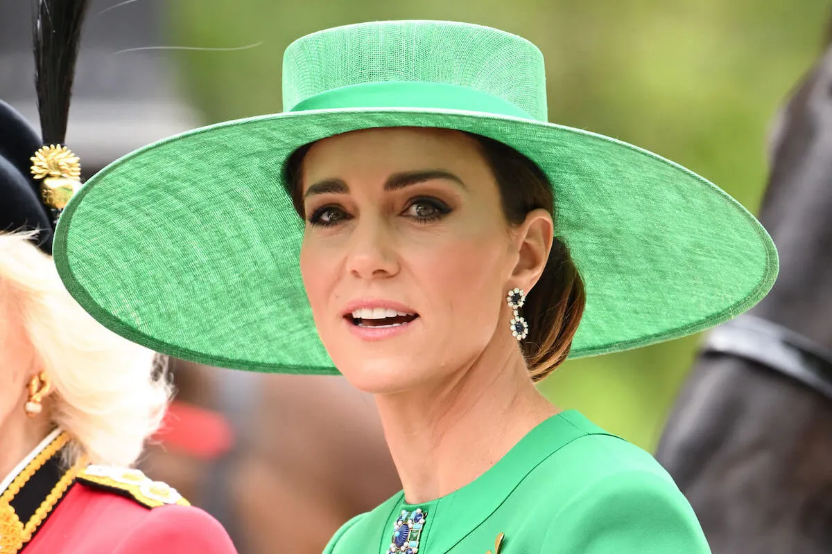 Kate Middleton, who may or may not attend the 2024 Trooping the Colour, at the 2023 celebration wearing a green hat and blazer.