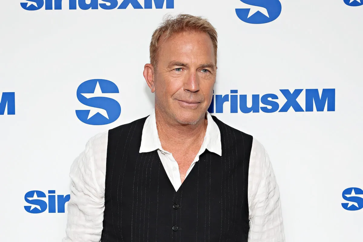 Kevin Costner, who respects Sarah Ferguson for handling Princess Diana 'Bodyguard' sequel meeting, in 2024 wearing a white shirt and black sweater vest