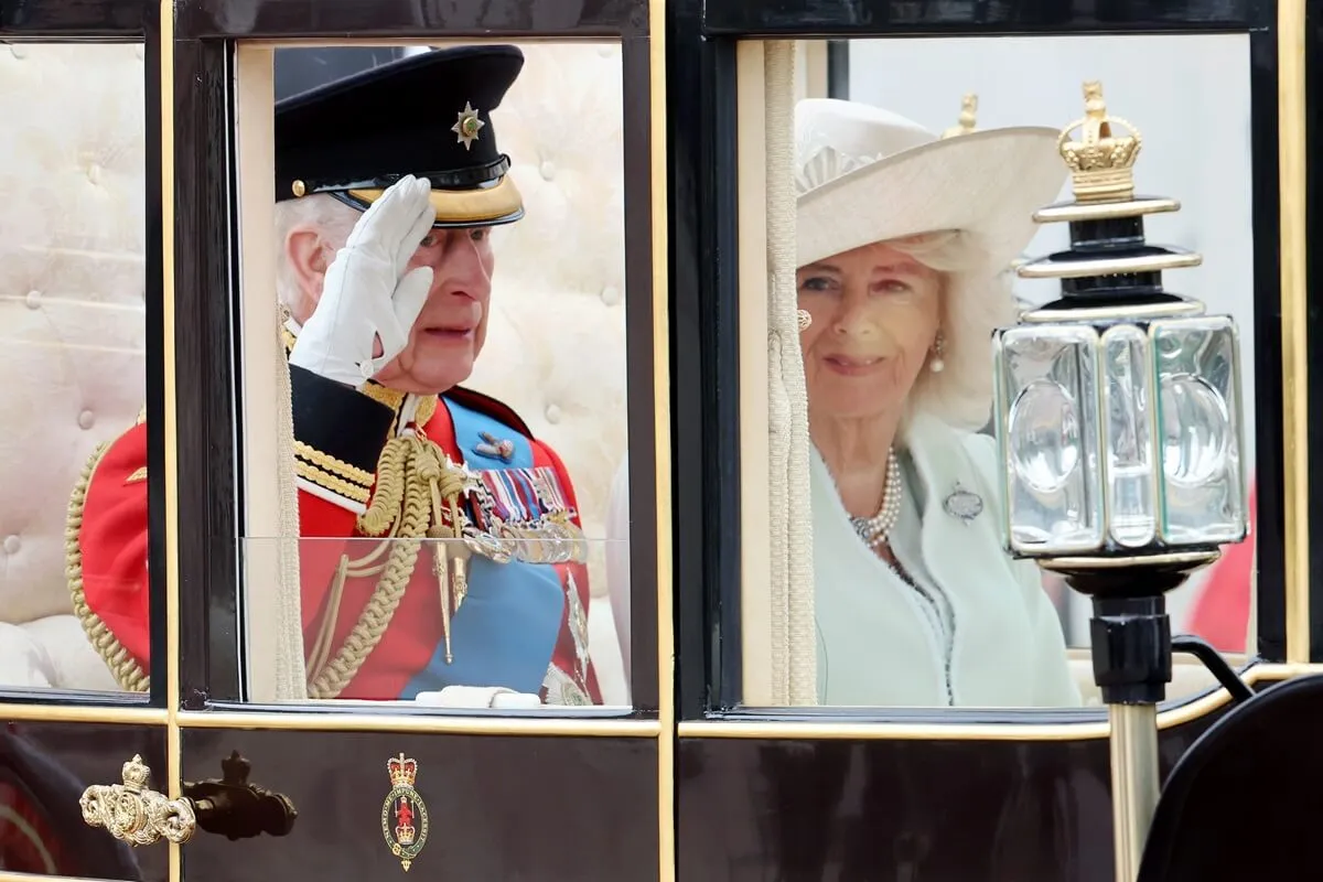 King Charles III and Queen Camilla riding in a carriage during Trooping the Colour