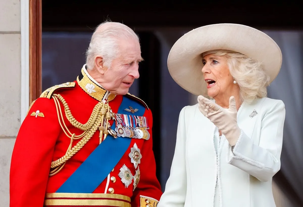 King Charles III and Queen Camilla watch a flypast from the balcony of Buckingham Palace after attending Trooping the Colour