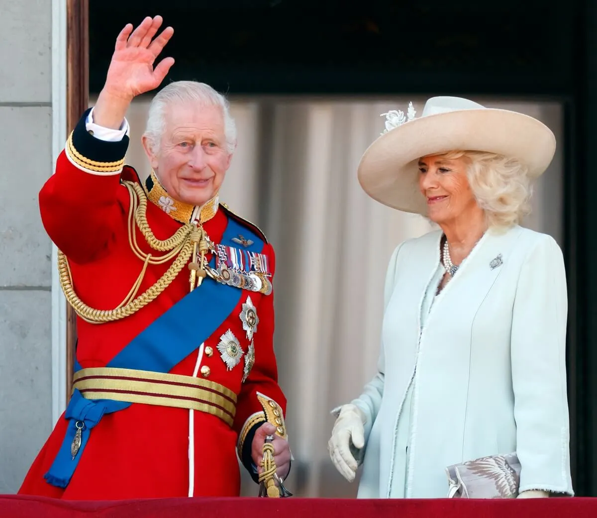 King Charles III and Queen Camilla watch an RAF flypast from the balcony of Buckingham Palace