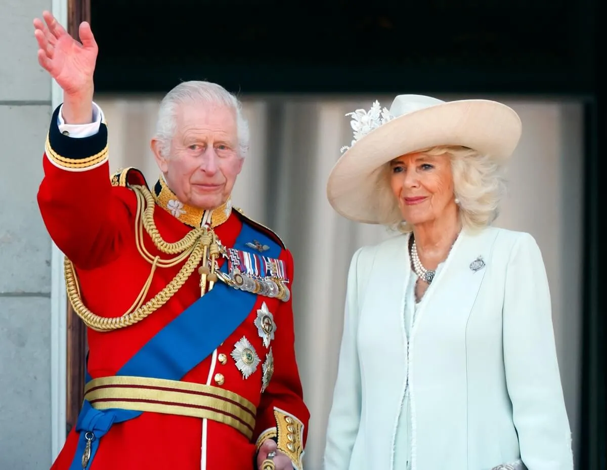 King Charles III and Queen Camilla watch an RAF flypast from the balcony of Buckingham Palace after attending Trooping the Colour