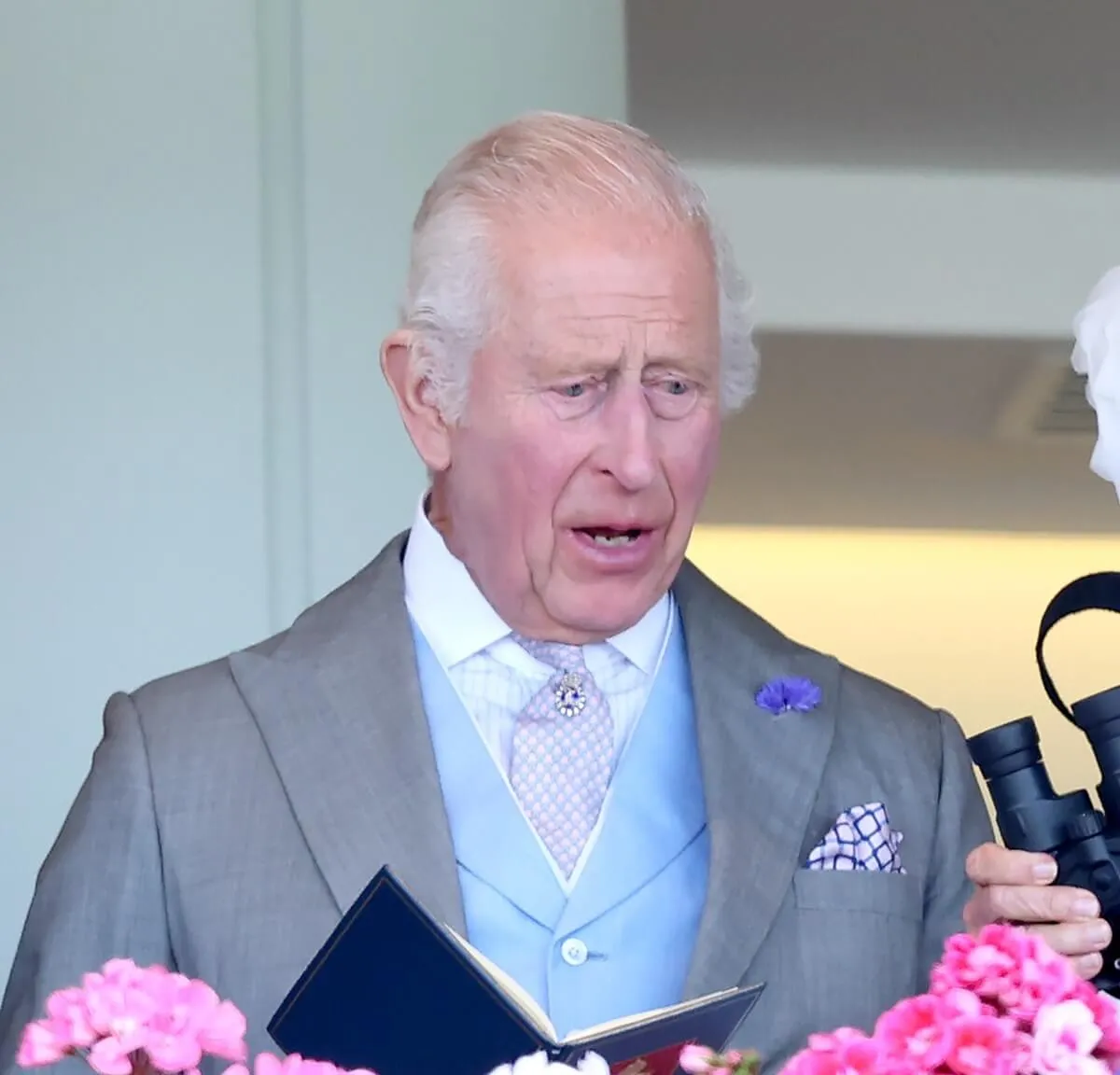King Charles III reacts whilst watching her horse race during day three of Royal Ascot 2024