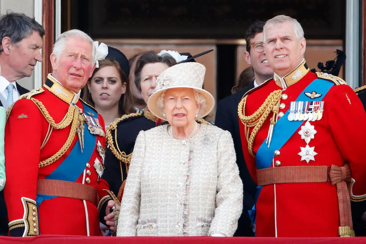 King Charles and Prince Andrew, whose feud has reached Prince William and Prince Harry levels, stand next to Queen Elizabeth II