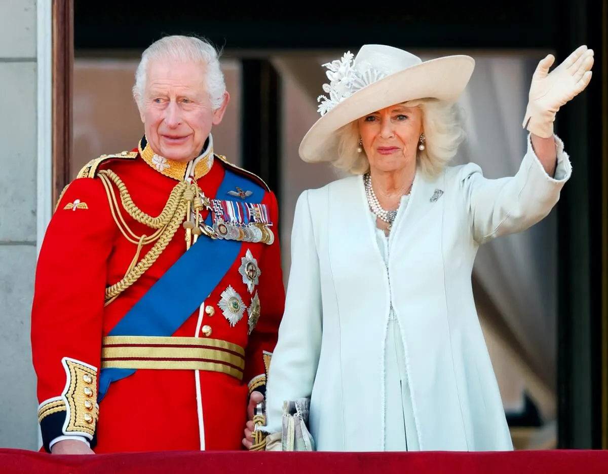 King Charles and Queen Camilla watch an RAF flypast from the balcony of Buckingham Palace after attending Trooping the Colour