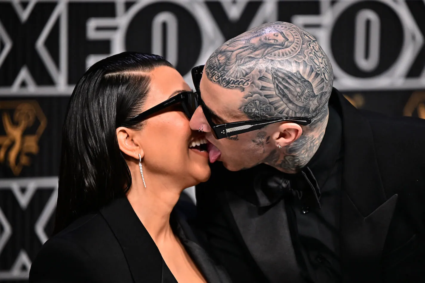 Kourtney Kardashian and Travis Barker kissing with tongue at the 2024 Emmy Awards