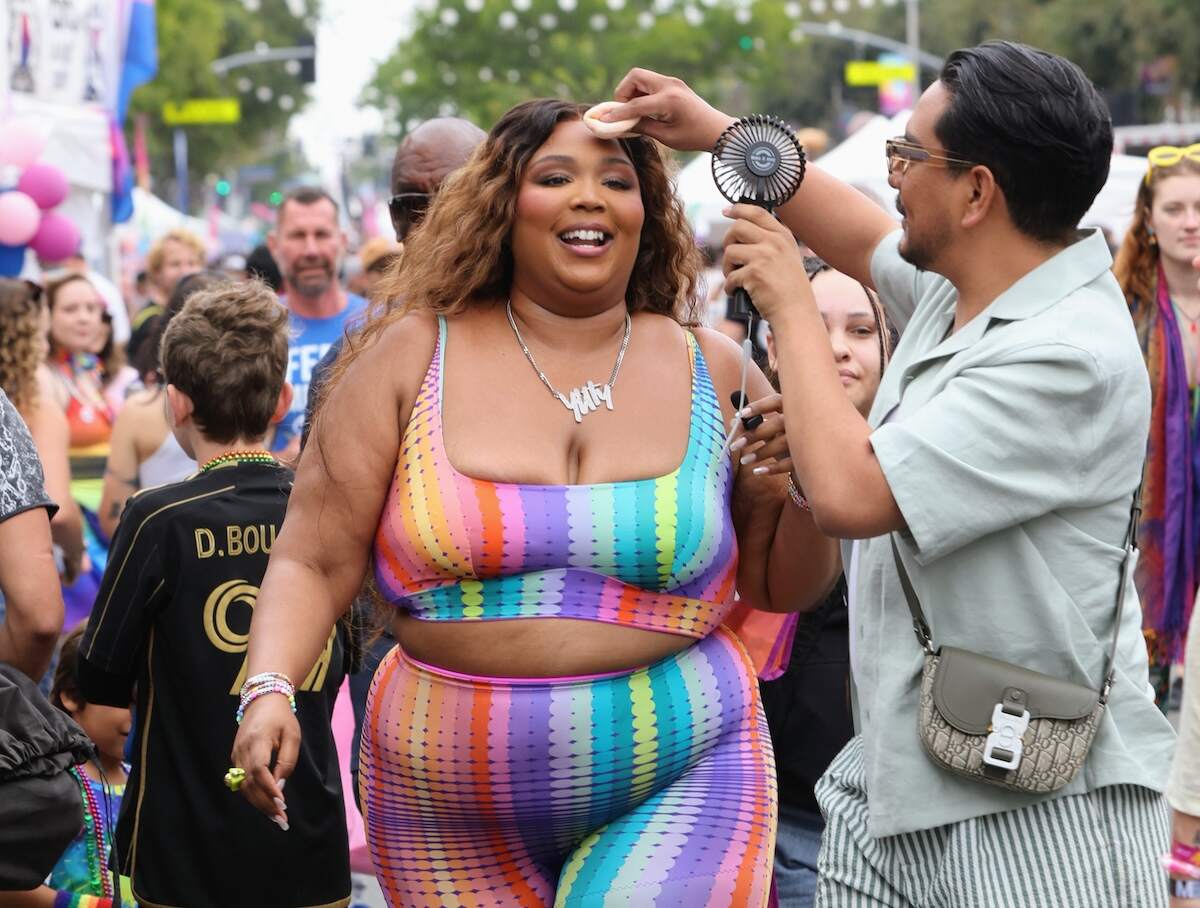 Singer Lizzo gets her face powdered as she walks through a crowd at the WeHo Pride Parade