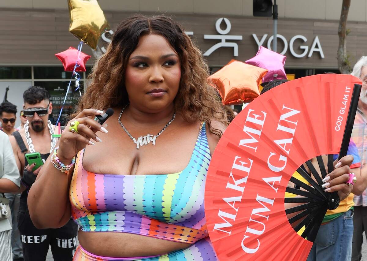 Singer Lizzo poses with a red fan at the WeHo Pride Parade