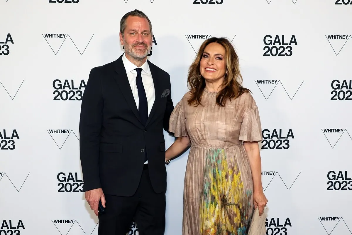 Peter Hermann and Mariska Hargitay attend the 2023 Whitney Gala and Studio Party wearing a suit and tan dress respectively.