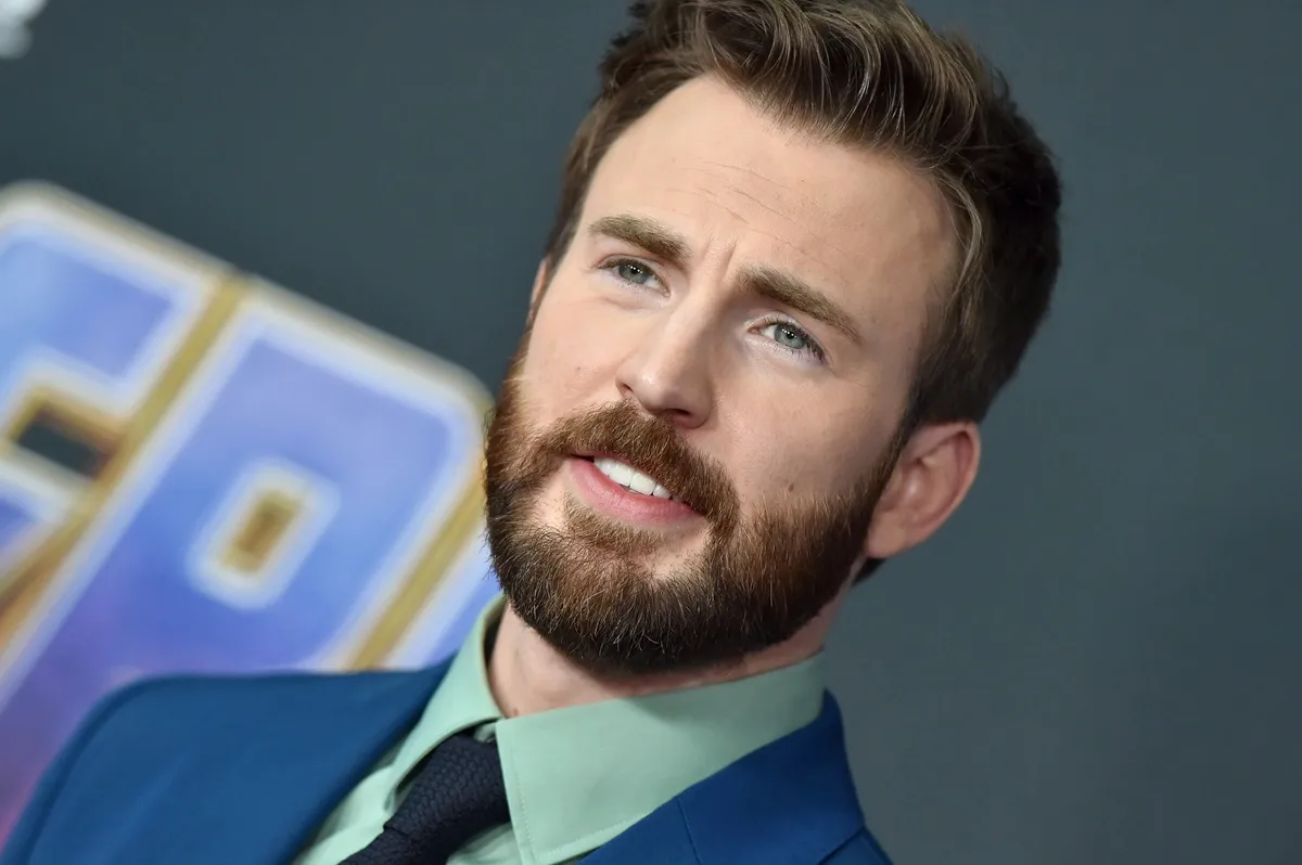 Chris Evans posing in a blue suit at the premiere of 'Avengers: Endgame'.