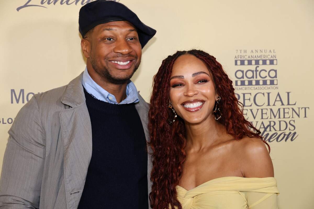 Couple Meagan Good and Jonathan Majors show big smiles on the red carpet at the AAFCA Special Achievement Honorees Luncheon