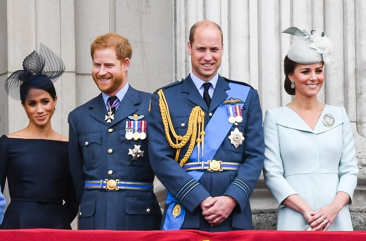 Meghan Markle, Prince Harry, Prince William, and Kate Middleton stand on the balcony of Buckingham Palace to view a flypast