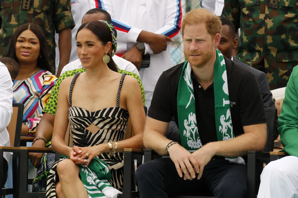 Meghan Markle and Prince Harry, who may have entered a 'new era' of privacy with Prince Archie and Princess Lilibet, sit next to each other in Nigeria