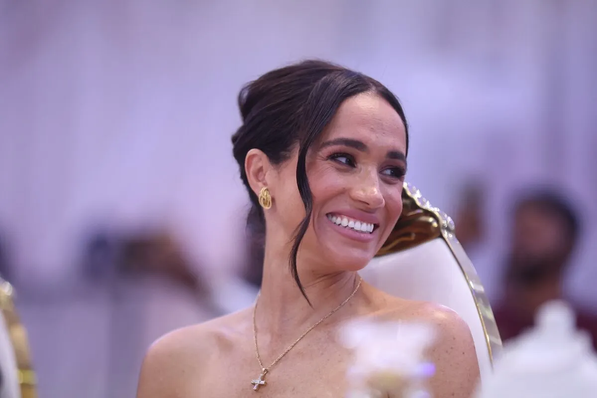 Meghan Markle smiles as she attends a Sit Out at the Nigerian Defense Headquarters in Abuja