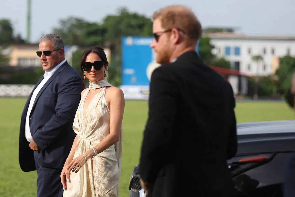 Meghan Markle, who reportedly has conditions for returning to the U.K., walks with Prince Harry