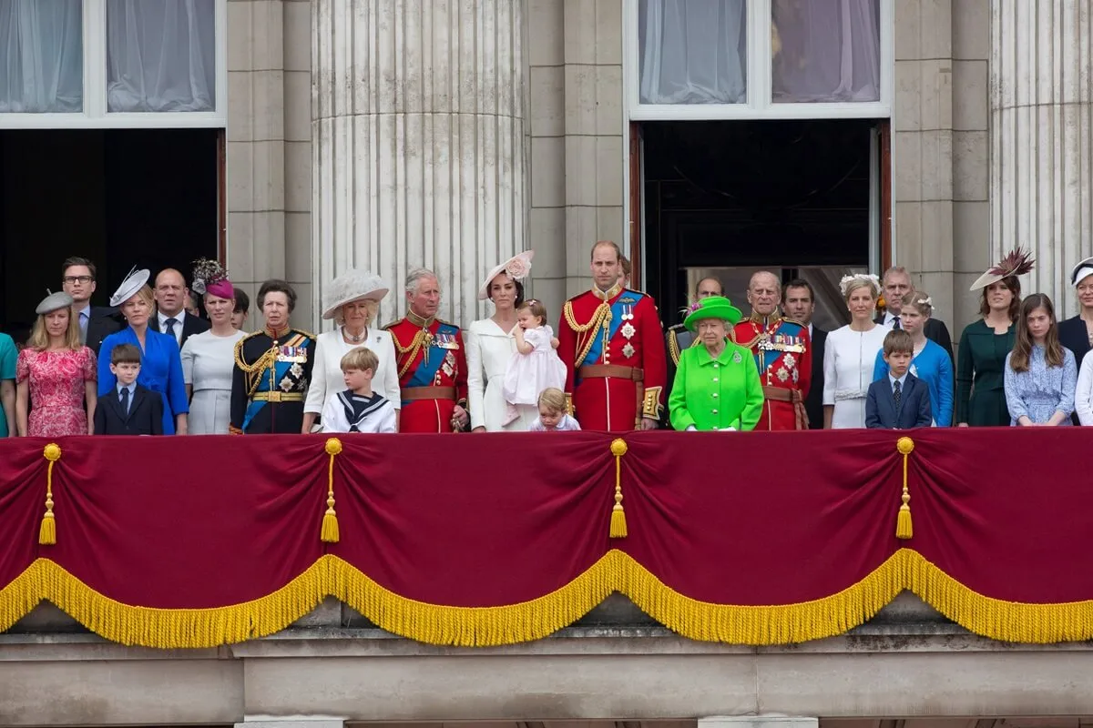 Members of the royal family standing on the balcony of Buckingham Palace to watch a fly-past of aircrafts by the Royal Air Force