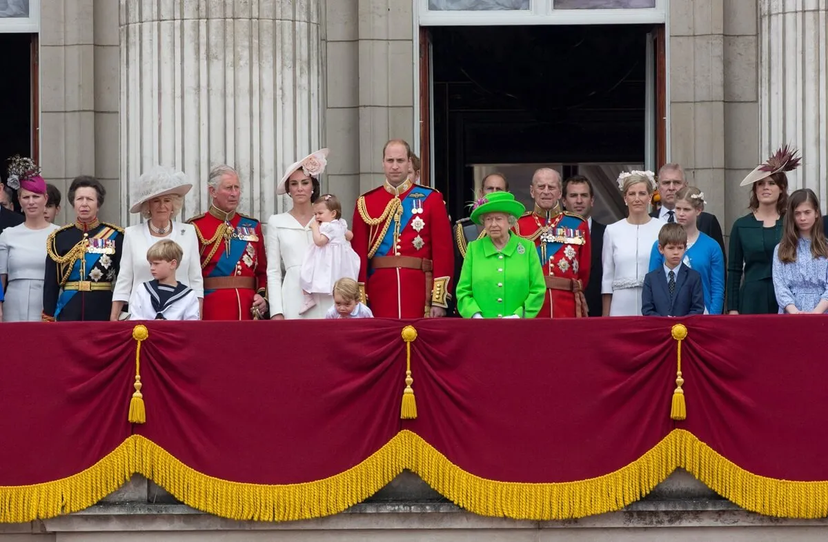 Members of the royal family standing on the balcony of Buckingham Palace to watch at flypast