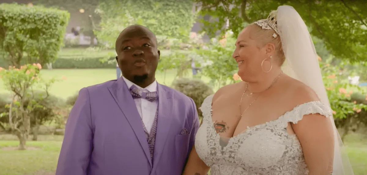 Michael Ilesanmi in a purple suit and Angela Deem in a wedding dress and veil in '90 Day Fiance'