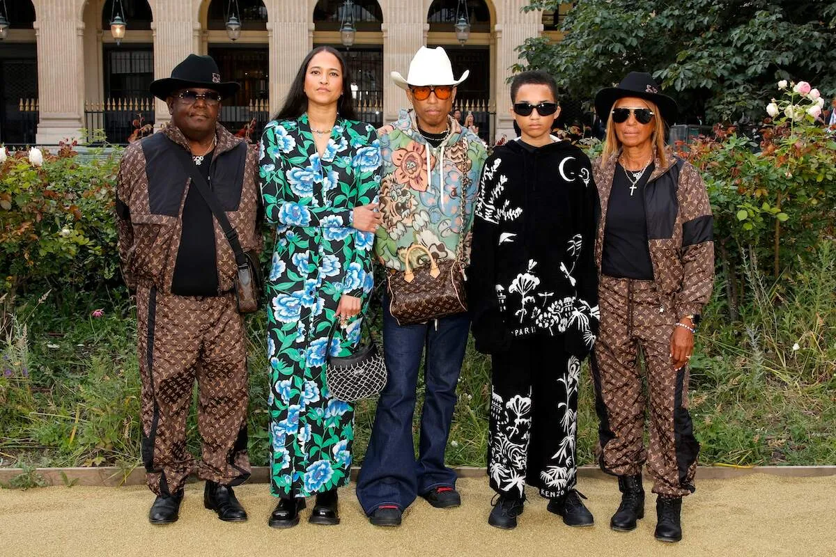 Pharrell Williams stands with his dad, wife, oldest son, and mom outside of the Kenzo fashion show in Paris