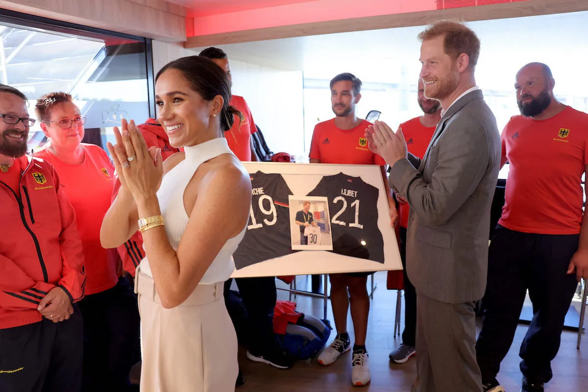 Prince Harry, who named 'distance' an 'essential' in royal life, stands next to Meghan Markle