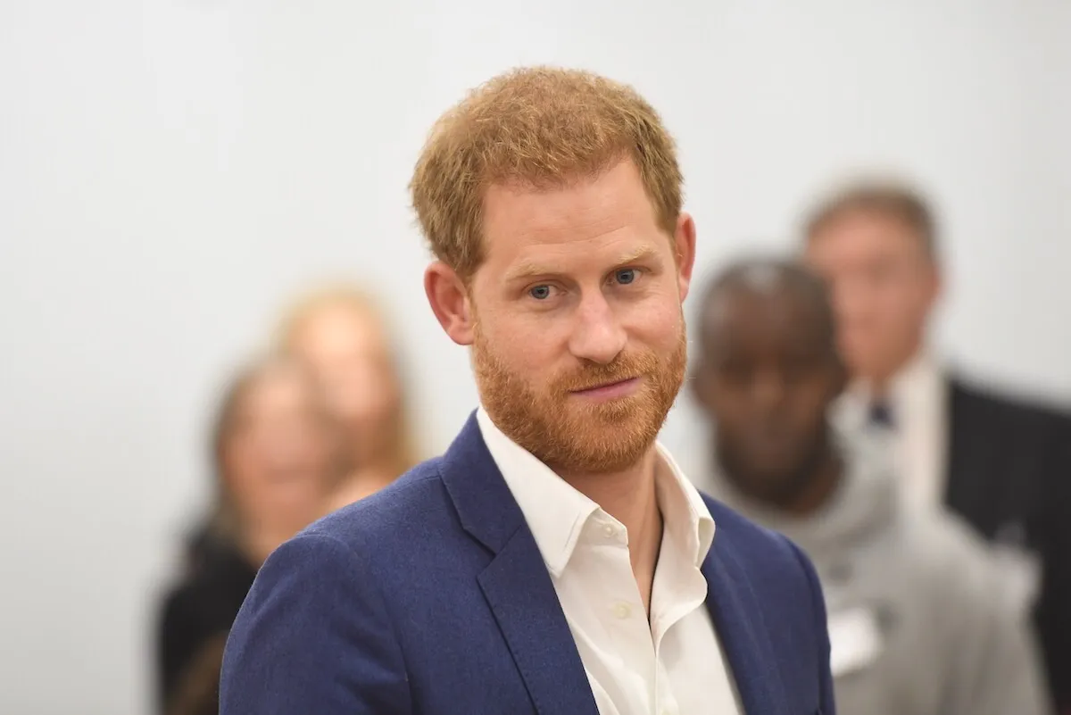 Prince Harry, who named the 'essential' part of being royal, looks on wearing a navy blazer.