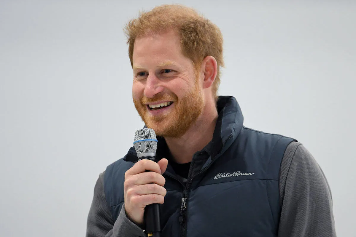 Prince Harry's who made quotes about fatherhood, in February 2024 holding a microphone.