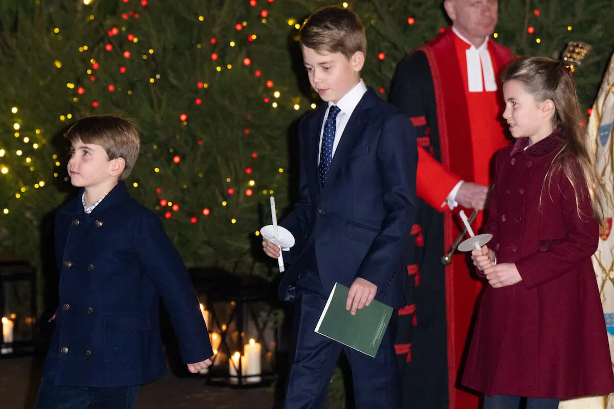 Prince Louis, Prince George, and Princess Charlotte, who may have to take part in National Service when they turn 18, in 2023 carrying candles