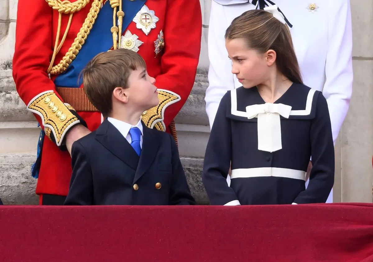 Prince Louis and Princess Charlotte standing on the Buckingham Palace balcony during Trooping the Colour