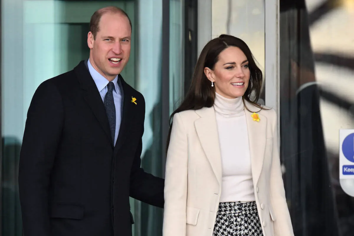 Prince William and Kate Middleton, whose Taylor Swift selfie has boosted their social media, walk next to each other.