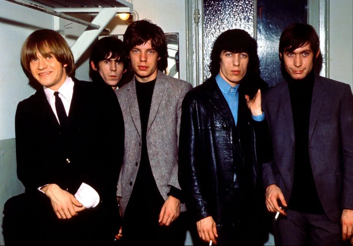 Brian Jones, Keith Richards, Mick Jagger, Bill Wyman and Charlie Watts of The Rolling Stones stand in a line together.