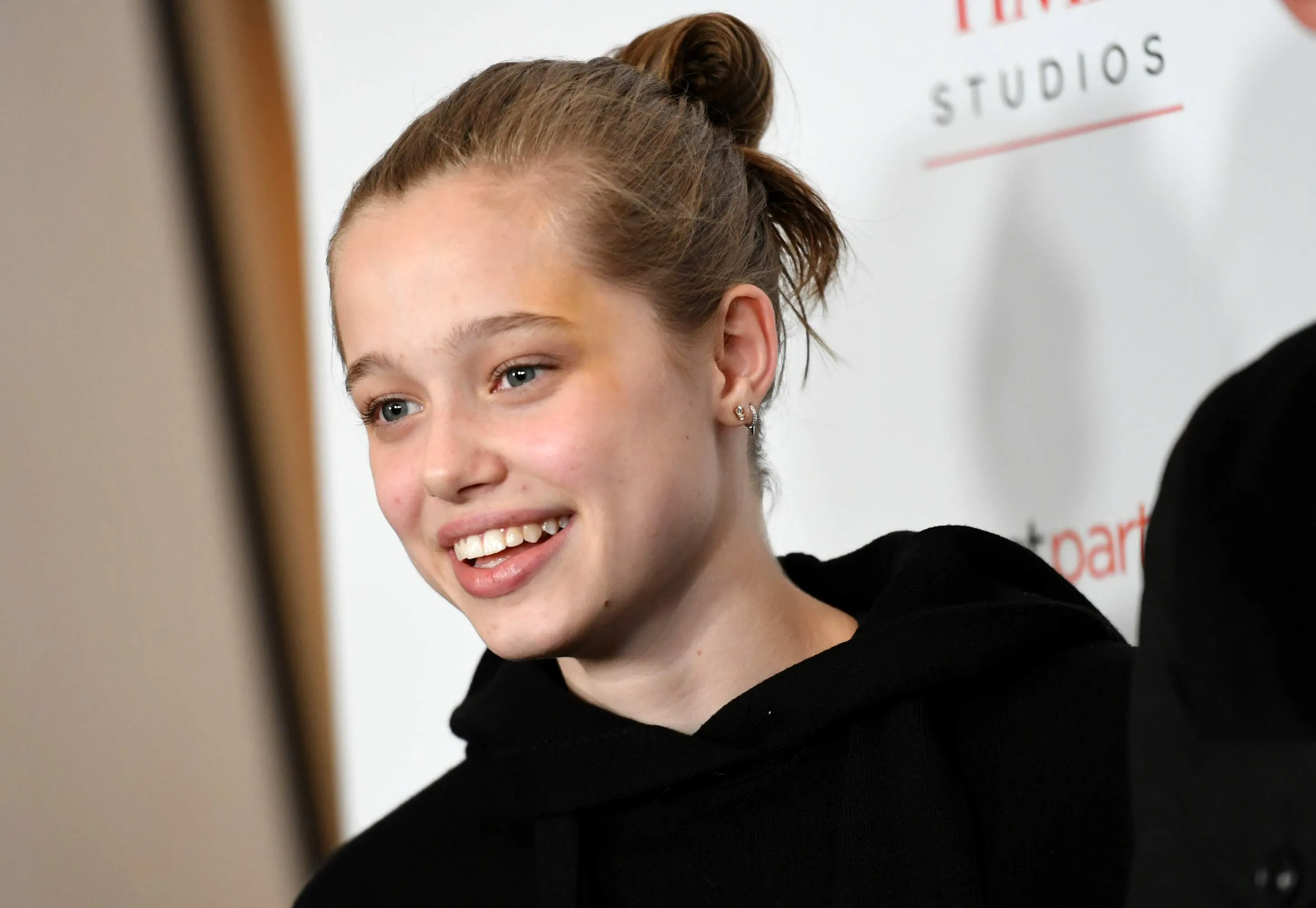 Angelina Jolie and Brad Pitt's daughter, Shiloh Jolie-Pitt, attends a movie premiere wearing a black hoodie