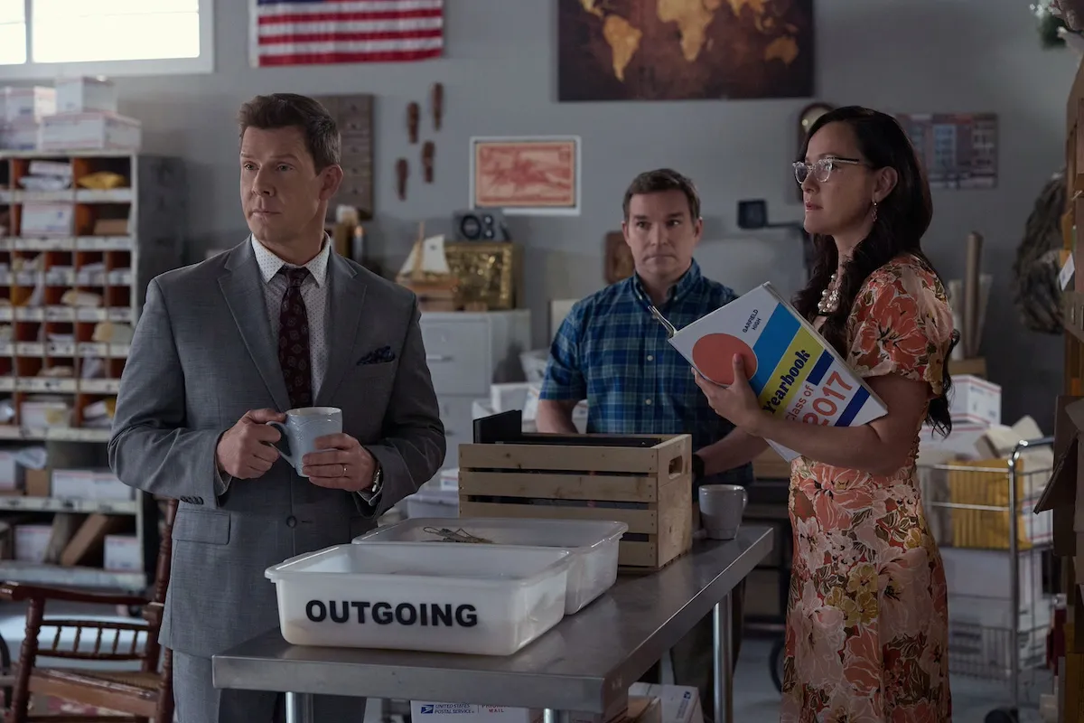 Three people standing around trays of mail in 'Signed, Sealed, Delivered: A Tale of Three Letters'