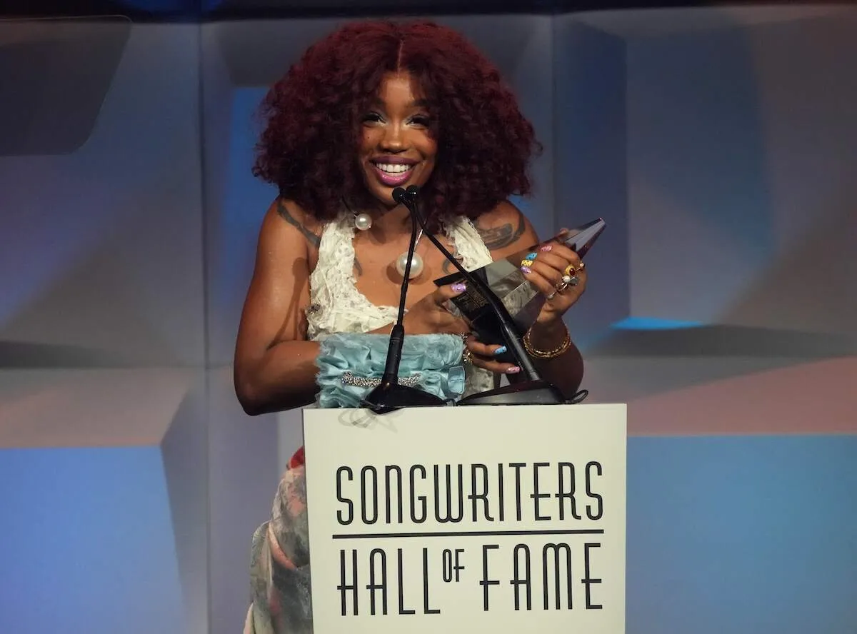 Wearing a ruffled dress, SZA speaks onstage during the 2024 Songwriters Hall of Fame Induction and Awards Gala